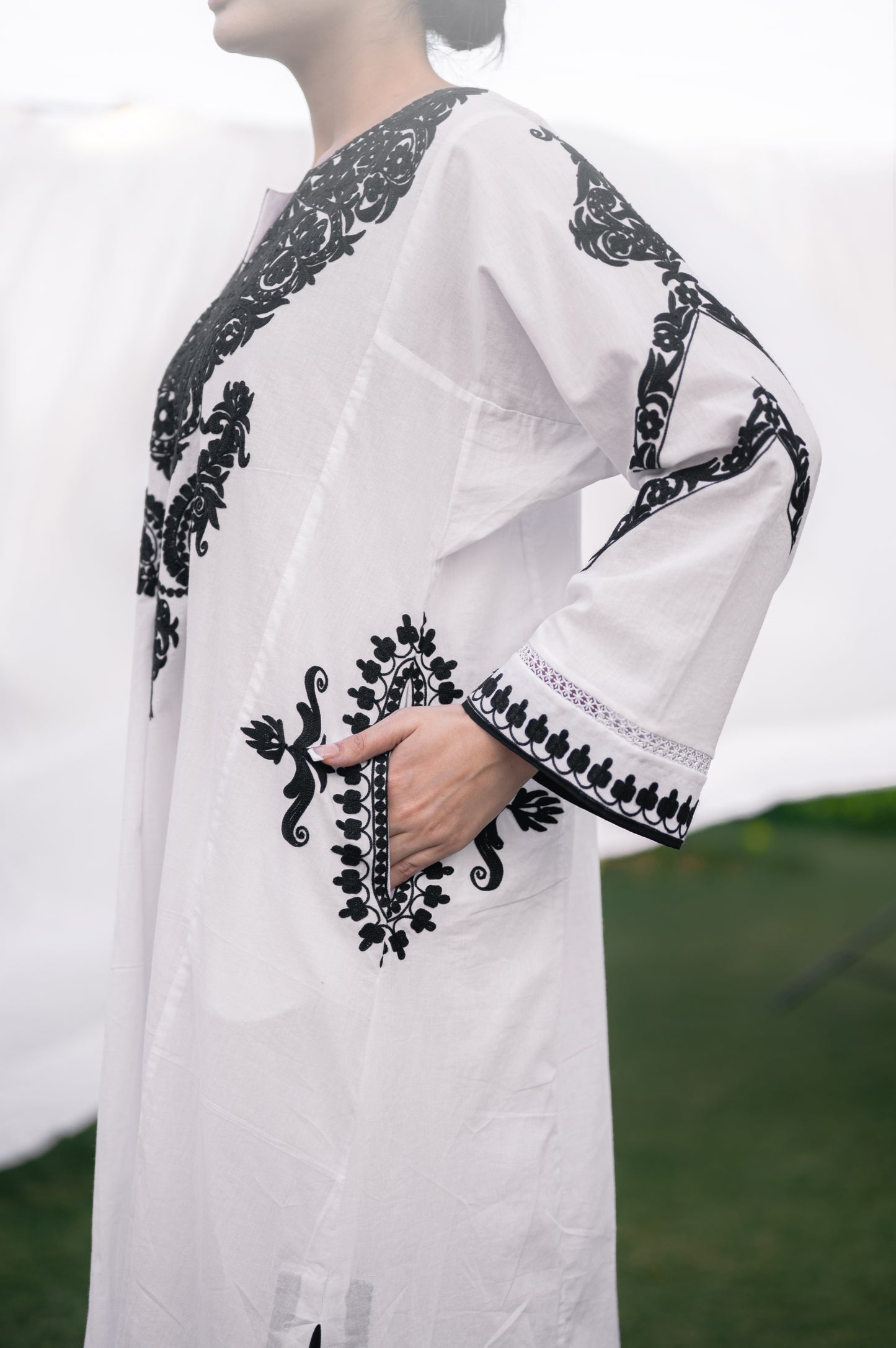 White mulmul phiran set with black aari embroidery