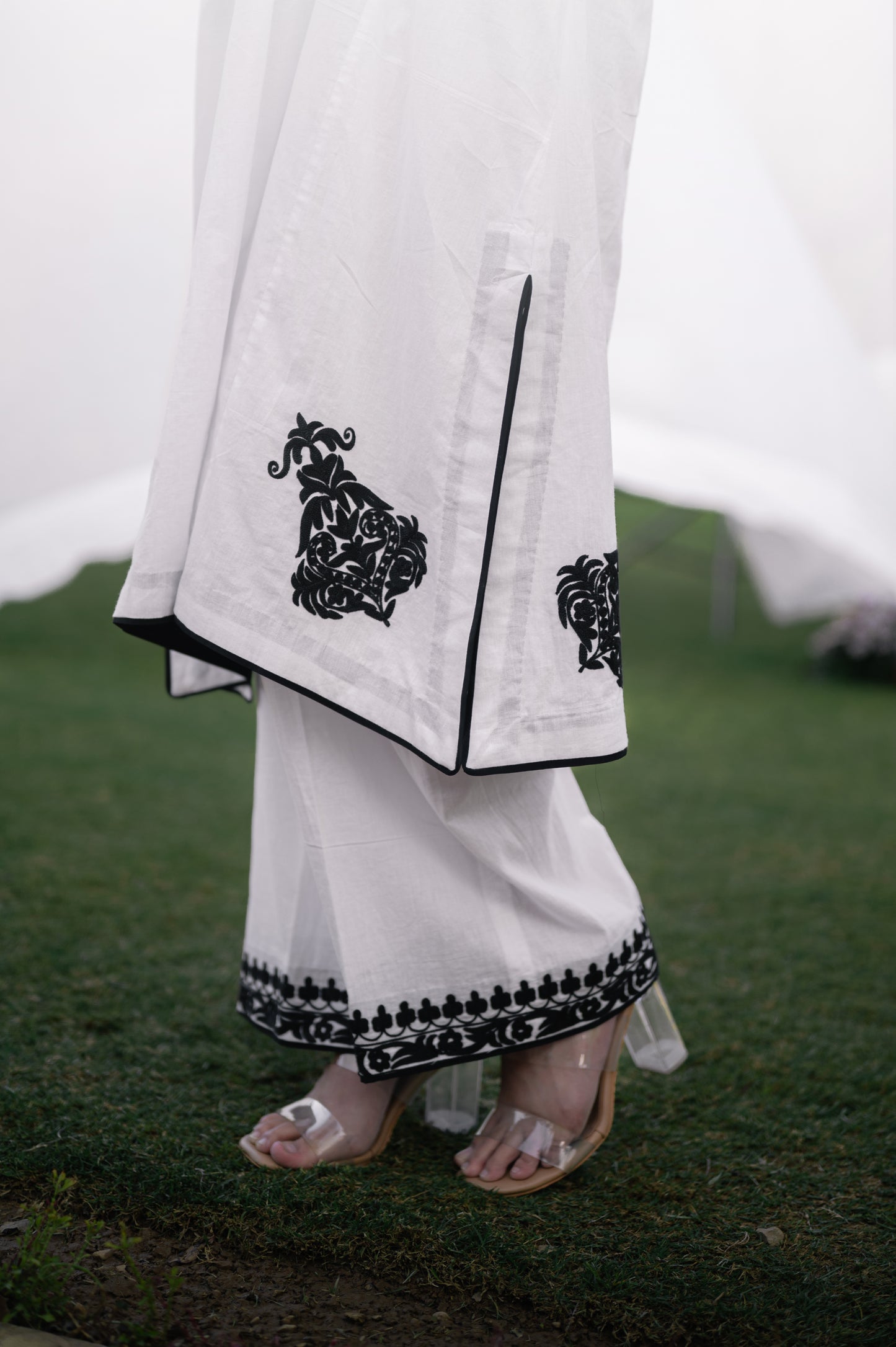 White mulmul phiran set with black aari embroidery