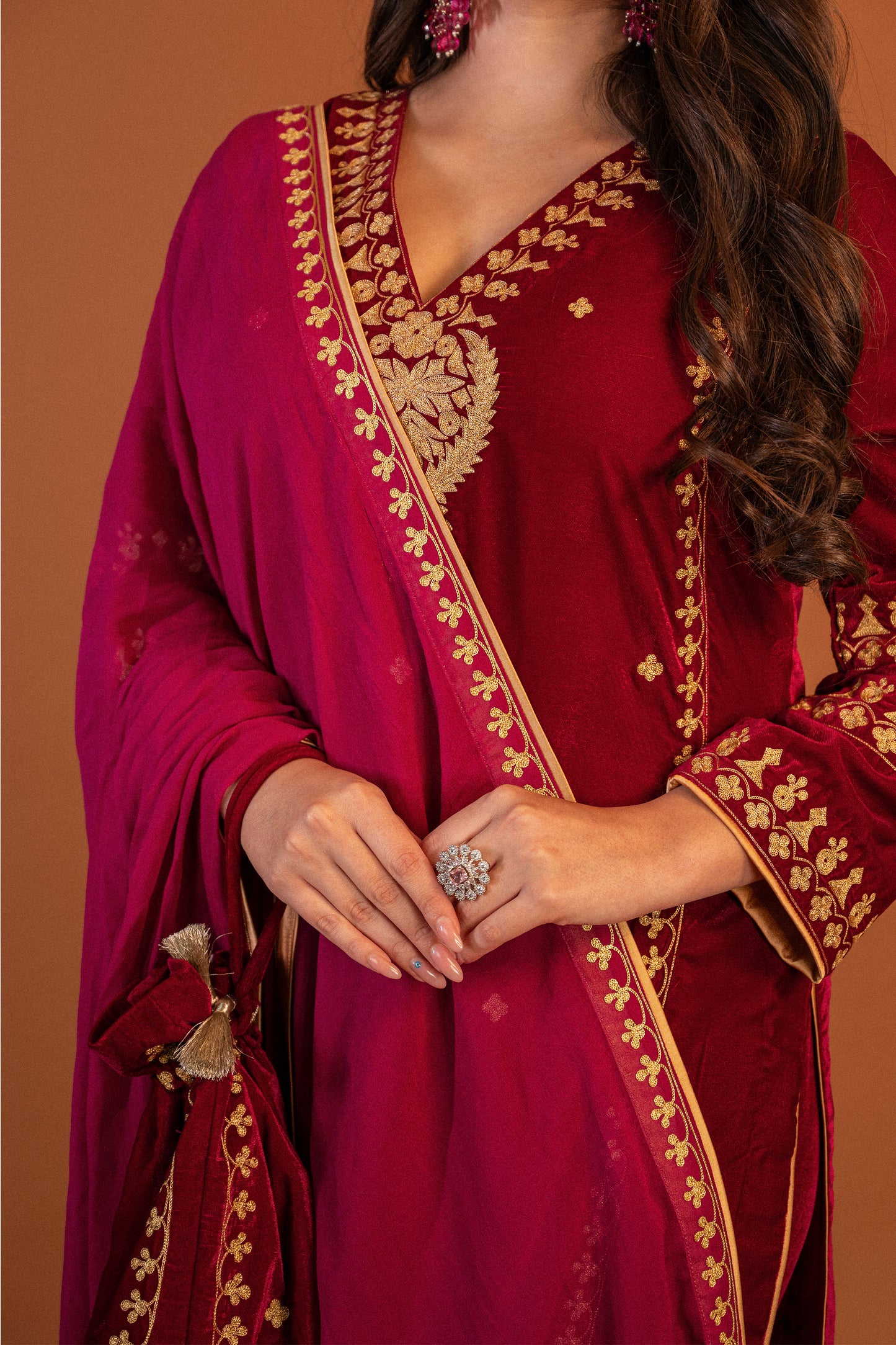 Reddish pink velvet aari tilla suit with potli
